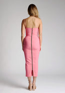 Back image of blonde model wearing a forest green midaxi dress with a alluring asymmetric design flatters every figure, while the bodycon silhouette accentuates your natural curves. The design featured is the Vesper Landen Fiesta Pink Dress