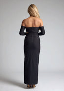 Back image of a blonde model wearing a black maxi dress with a strapless design, off-shoulder design, and a stylish side cut-out, the design features Vesper Leena Black Maxi Dress