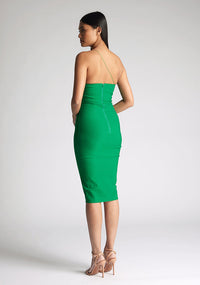 Back quarter image of the model wearing an emerald one shoulder midi dress with a asymmetrical neckline with one strap, bodycon silhouette and discreet back zip for seamless fit. The design featured is the Vesper Leslie Emerald One Shoulder Midi Dress