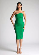 Front image of the model wearing an emerald one shoulder midi dress with a asymmetrical neckline with one strap, bodycon silhouette and discreet back zip for seamless fit. The design featured is the Vesper Leslie Emerald One Shoulder Midi Dress