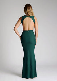 Back image of a model wearing a green maxi dress, featuring a slash neckline, open back, subtle fishtail skirt and gold buttons at back of neck. The style featured is Vesper Lincoln Forest Green Maxi Dress