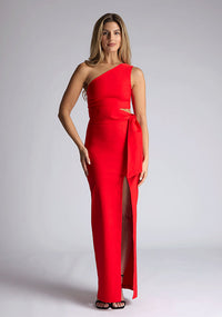 Front image of the model wearing an red maxi dress with a sleeveless stunner boasts an asymmetric design and a flattering wrap belt and front skirt split. The design featured is the Vesper Lisbeth Red Maxi Dress