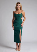 Front image of blonde model wearing a Forest Green Midaxi Dress with a scoop neckline and thin straps, front skirt split and a bodycon fit. The design features  is Vesper Marilynn Forest Green Midaxi Dress