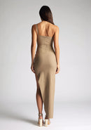 Back image of model wearing a taupe one shoulder maxi dress with a asymmetrical neckline, one-shoulder design, and a leg split. The design featured is the  Vesper Melanie Taupe One Shoulder Maxi Dress