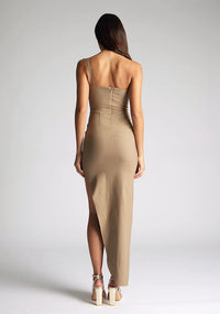 Back image of model wearing a taupe one shoulder maxi dress with a asymmetrical neckline, one-shoulder design, and a leg split. The design featured is the  Vesper Melanie Taupe One Shoulder Maxi Dress