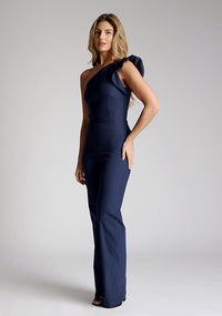 Front quarter image of the model wearing a navy one shoulder jumpsuit
with a asymmetric neckline and one shoulder with a ruffle detail and wide leg finish elongates your silhouette, while the centre back zip ensures a sleek fit. The design featured is the Vesper Monty Navy One Shoulder Jumpsuit