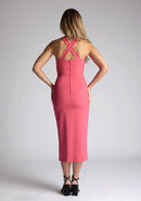 Back mage of model wearing a pink sweetheart midaxi dress with a plunge sweetheart neckline with wide straps that cross at the back and a front skirt split. The design featured is the Vesper Poppy Pink Sweetheart Midaxi Dress