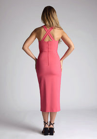 Back mage of model wearing a pink sweetheart midaxi dress with a plunge sweetheart neckline with wide straps that cross at the back and a front skirt split. The design featured is the Vesper Poppy Pink Sweetheart Midaxi Dress