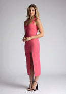 Front quarter image of model wearing a pink sweetheart midaxi dress with a plunge sweetheart neckline with wide straps that cross at the back and a front skirt split. The design featured is the Vesper Poppy Pink Sweetheart Midaxi Dress