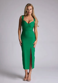 Front image of a model wearing a green cut out midaxi dress with a sweetheart neckline with wide straps, a side cut-out and front skirt split. The design featured is the Vesper Porticini Emerald Green Cut Out Midaxi Dress