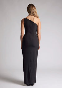 Back quarter image of the model wearing a black maxi dress with a one-shoulder dress, delicate thin strap, a chic front cutout and body con fit creating an effortlessly stylish look.  The design featured is the Vesper Rafaela Black Maxi Dress