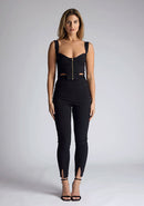 Front image of a model wearing a black high waist trousers with a  high waist and fitted silhouette create a flattering shape, while the small splits at the front add a touch of elegance.The design featured is the Vesper Raven Black High Waist Trousers pair with Vesper Juno Black Crop Top