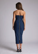 Back image of a model wearing a navy midaxi dress, featuring a strapless neckline with gold zip at the back. The design featured is the Vesper Shelbie Navy Strapless Midaxi Dress