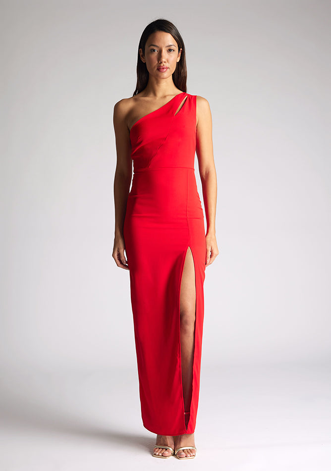 Front image of model wearing red asymmetric maxi dress with a asymmetric neckline with one shoulder detail, front bodice cut-out and front skirt split. The design featured is Vesper Verity Red Asymmetric Maxi Dress