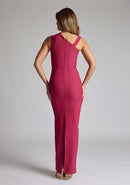 Back image of a model wearing a raspberry asymmetric maxi dress with a asymmetric neckline silhouette, back skirt split and ruched detailing enhances the dress's allure. The design featured is the Vesper Wyatt Raspberry Asymmetric Maxi Dress