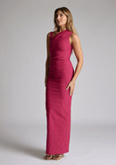 Front quarter image of a model wearing a raspberry asymmetric maxi dress with a asymmetric neckline silhouette, back skirt split and ruched detailing enhances the dress's allure. The design featured is the Vesper Wyatt Raspberry Asymmetric Maxi Dress